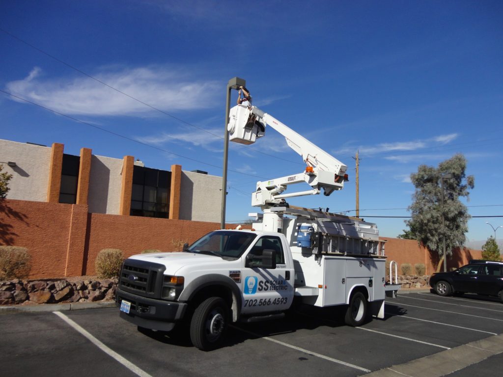 Bucket truck servicing parking lot light